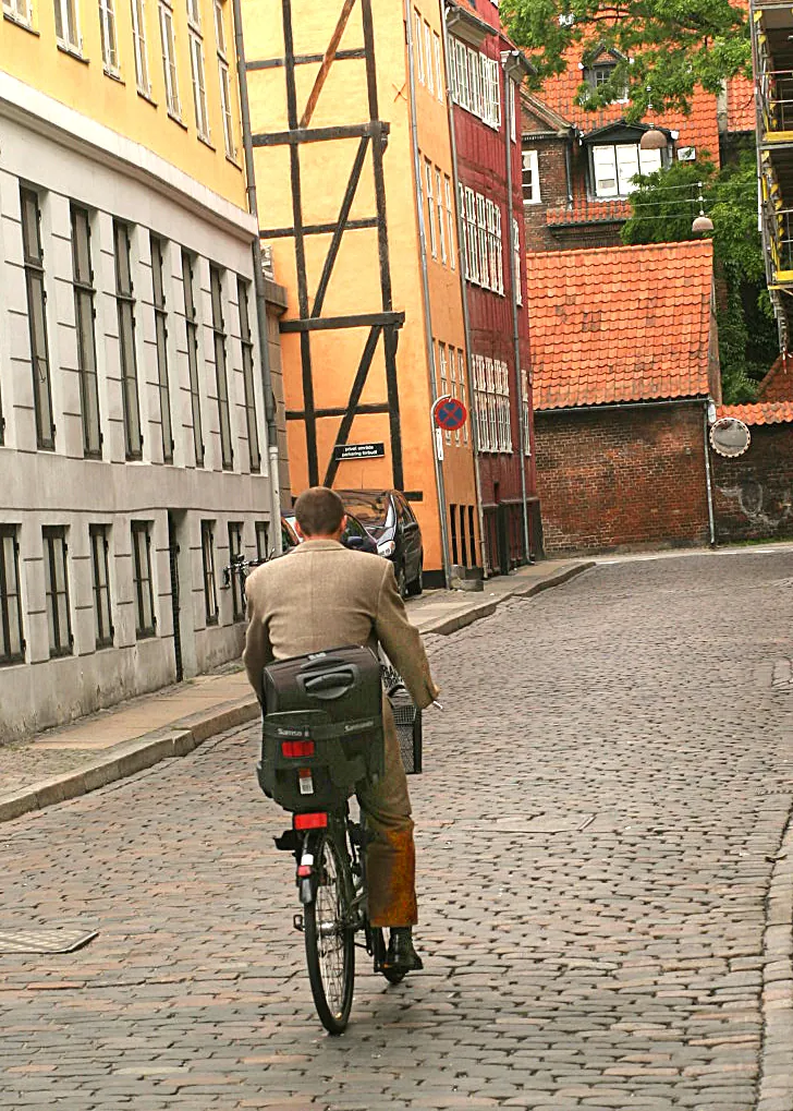 Urban bicycle commuter on a cobbled street
